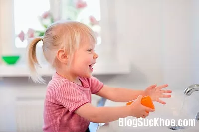 Toddler girl washing her hands